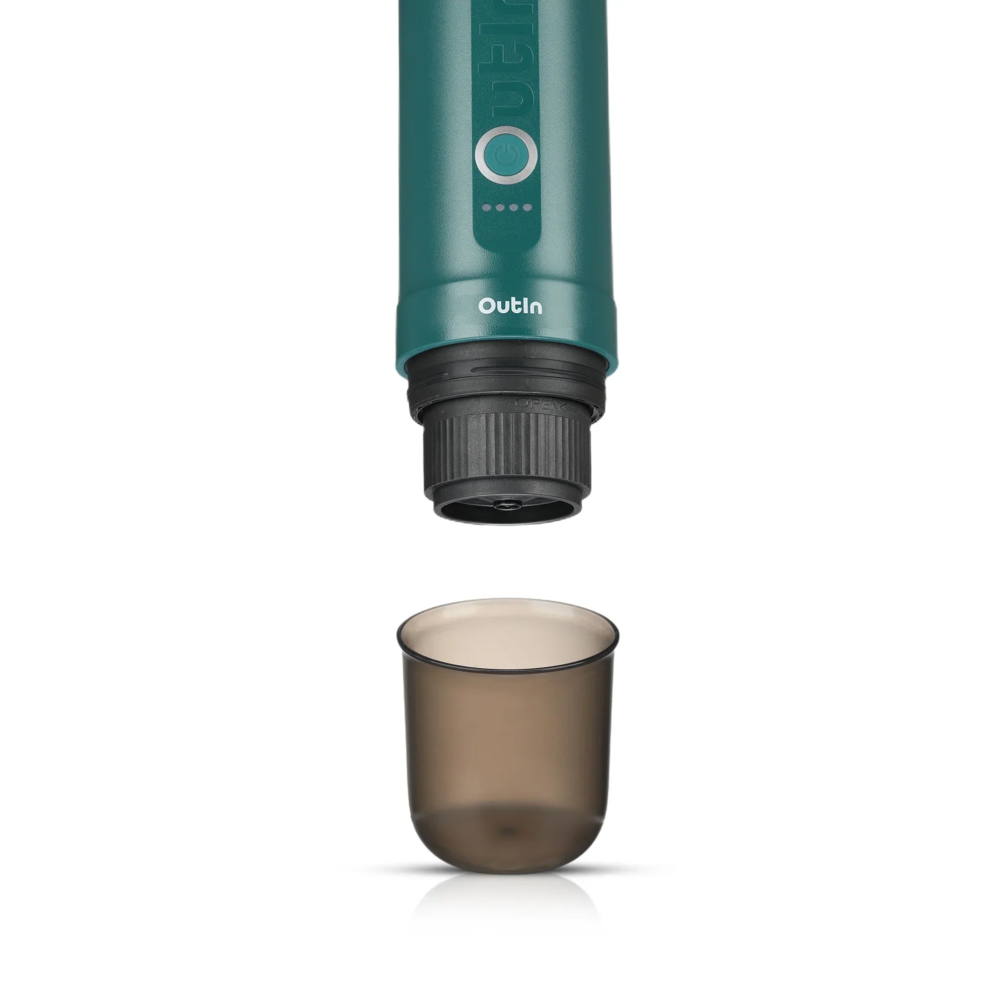OutIn Nano portable espresso machine green brewing head above smoky grey BPA-free cup on white background.