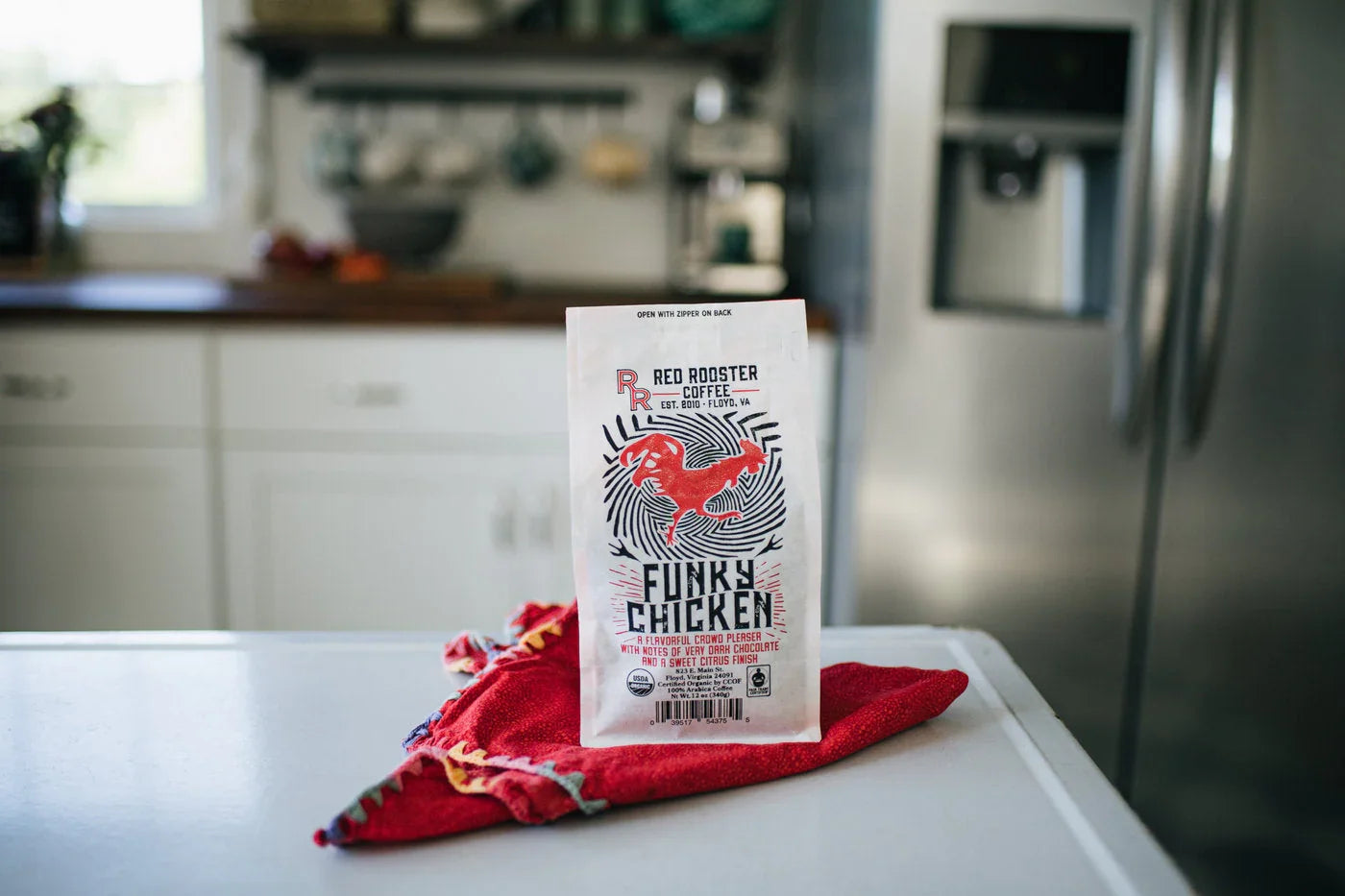 Red Rooster Coffee Organic Funky Chicken blend bag with red rooster graphic, notes of pecan praline & milk chocolate truffle.