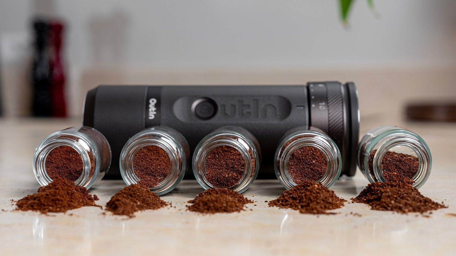 Outin portable coffee grinder showing five grind sizes from coarse to fine for espresso brewing