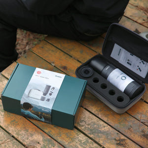 Space Grey OutIn Traveler Espresso Gift Set with red dot winner 2023 packaging and protective case on wooden table.