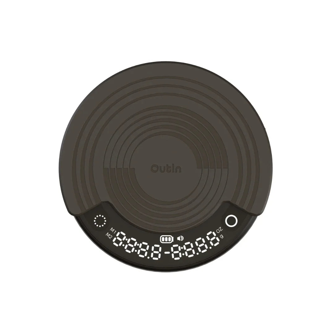 OutIn Claro coffee scale in dark gray, round design with concentric texture, showing timer, weight, and brewing modes M1/M2.