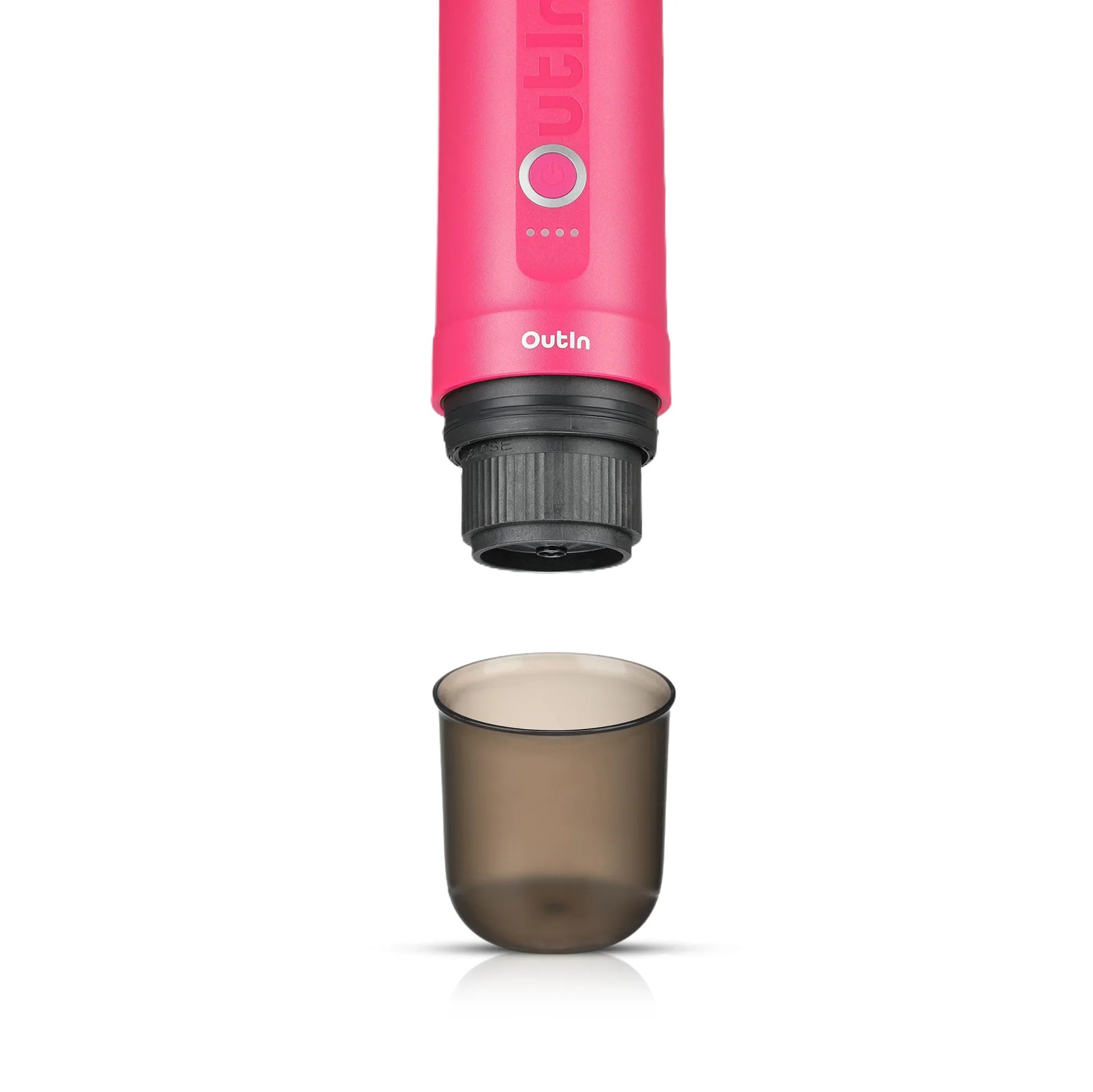 Bright pink OutIn Nano portable espresso machine brewing head above smoky grey BPA-free cup on white background.