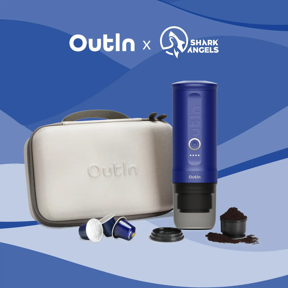 Ocean blue Nano portable espresso machine set with carrying case, capsules, and ground coffee on a blue background.