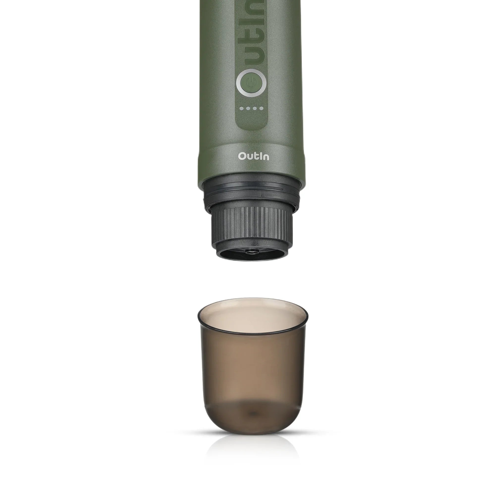 Green OutIn Nano portable espresso machine brewing head above translucent smoky grey BPA-free cup.