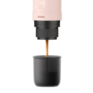 Rose Quartz Nano Portable Espresso Machine brewing rich espresso into a dark gray cup, showcasing the brewing process.