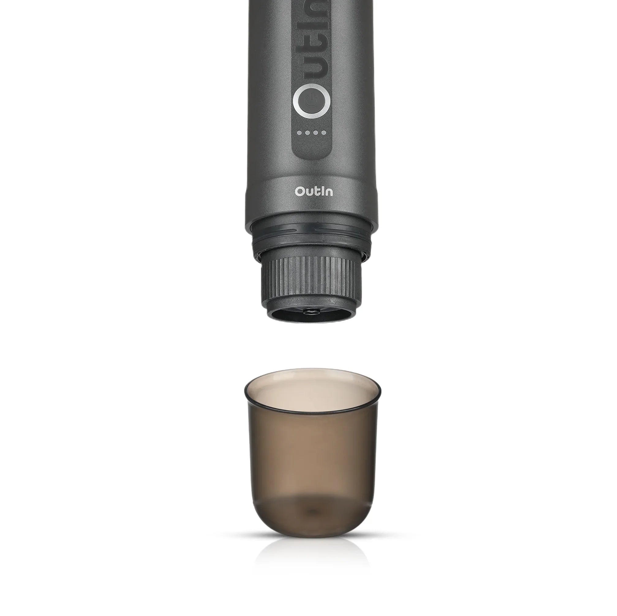 OutIn Nano portable espresso machine brewing head above empty smoky grey BPA-free cup on white background.