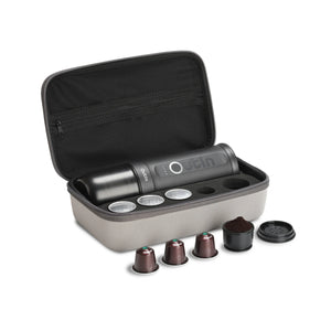 Space Grey OutIn traveler espresso maker with coffee capsules and ground coffee in its protective case.