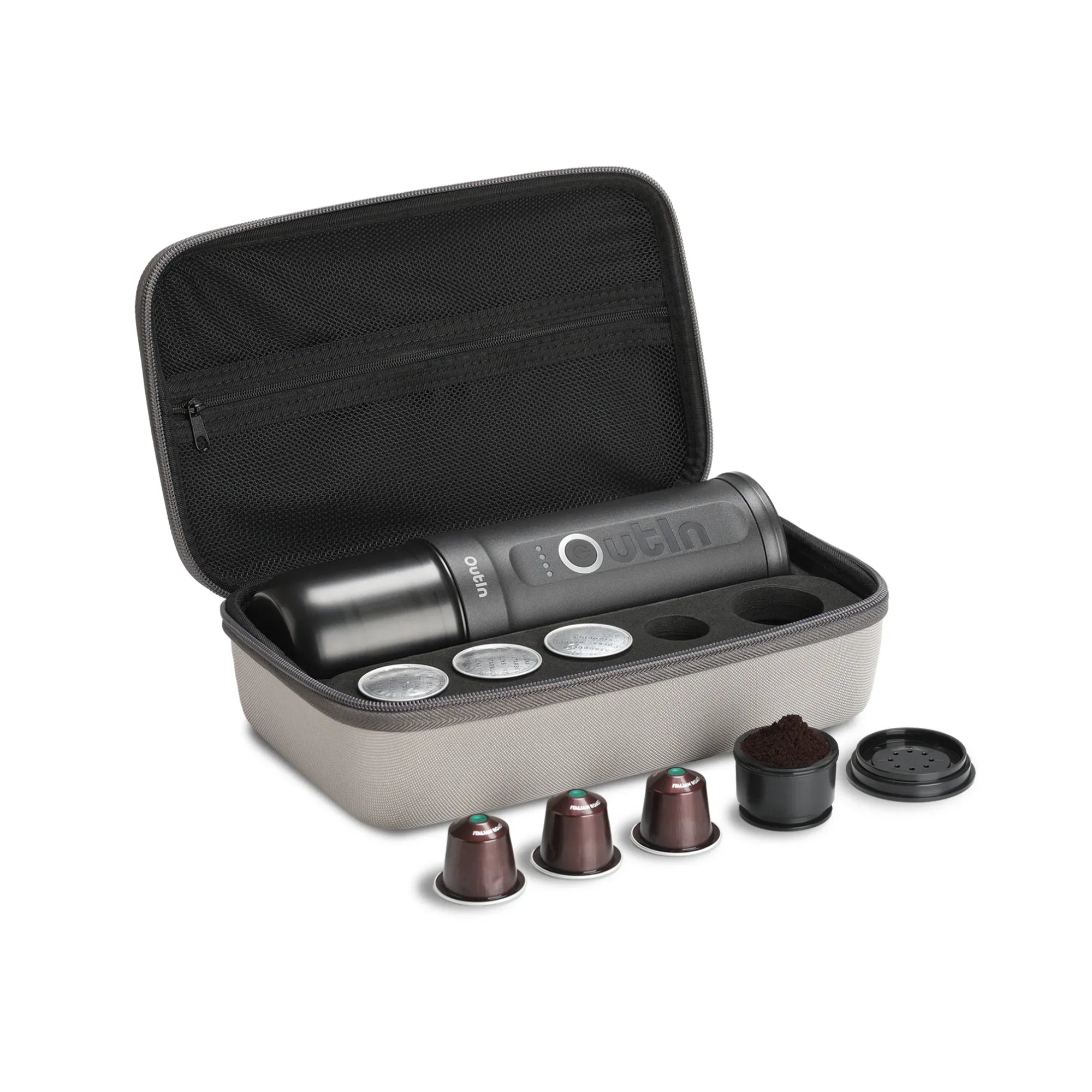 Space Grey OutIn traveler espresso maker with coffee capsules and ground coffee in its protective case.