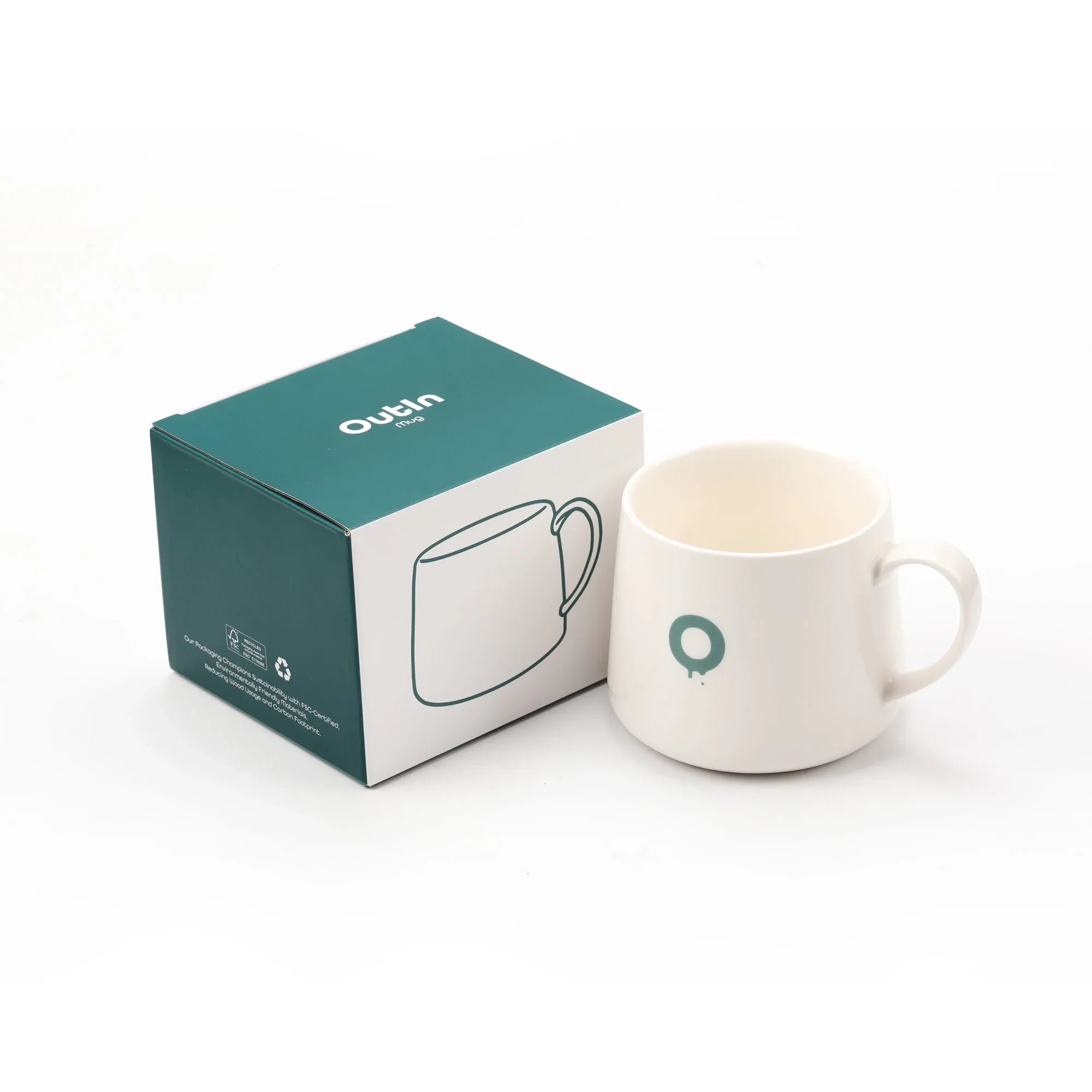 OutIn portable espresso mug, white ceramic with teal "O" graphic, next to its teal retail box with mug line drawing.