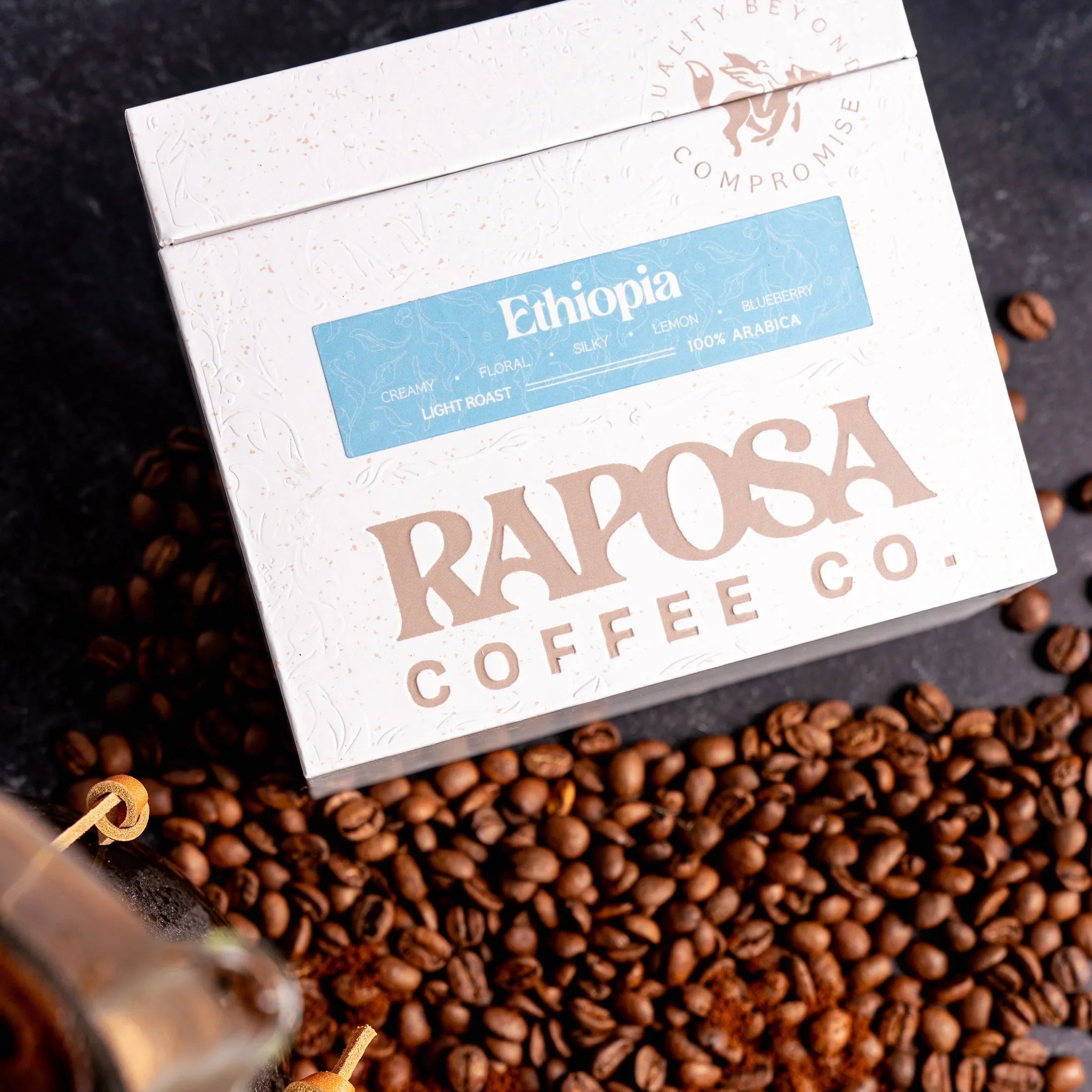 Raposa Coffee Ethiopia Light Roast box with whole beans and tasting notes: creamy, floral, silky, lemon, blueberry.