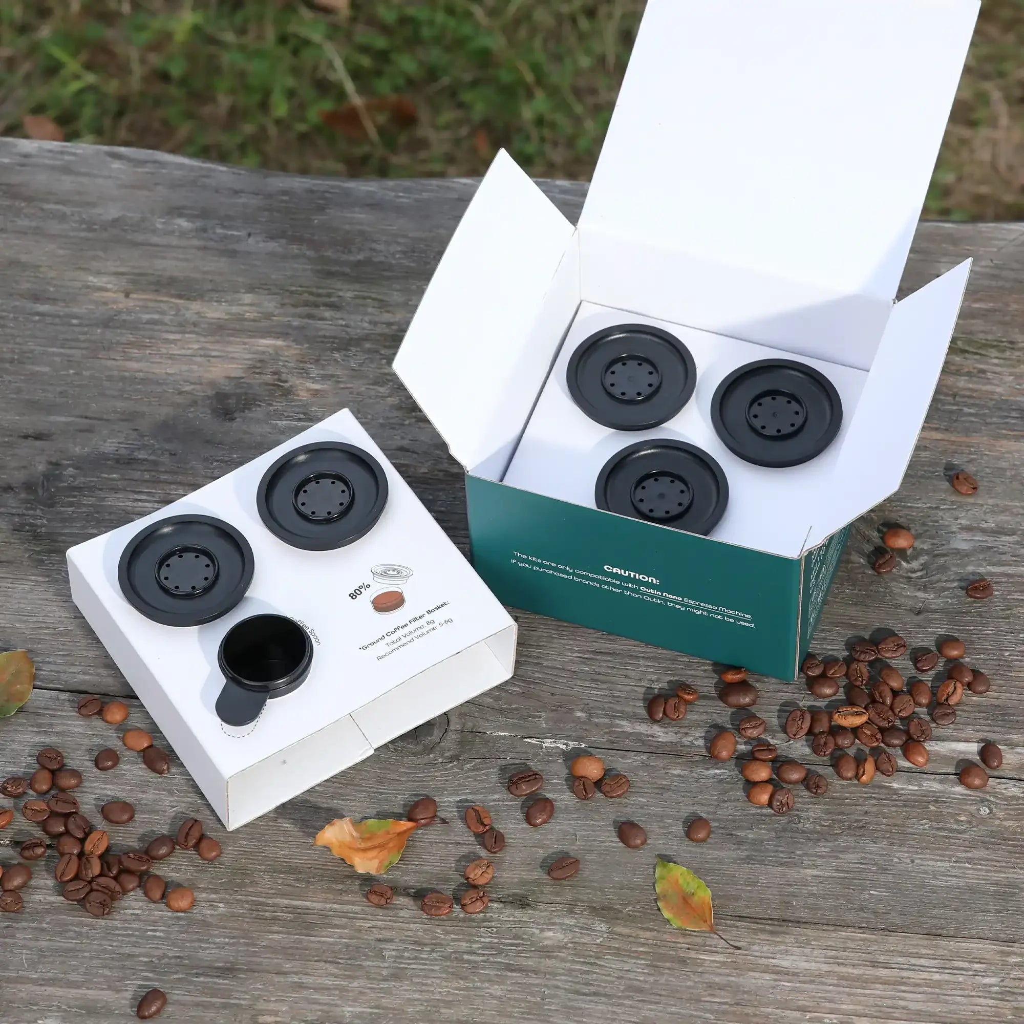 OutIn Nano Espresso Machine ground coffee filter baskets kit with 5 baskets and 1 spoon in packaging.