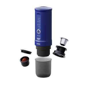 Ocean blue Nano portable espresso machine with ground coffee, capsule adapter, and cup on white background.