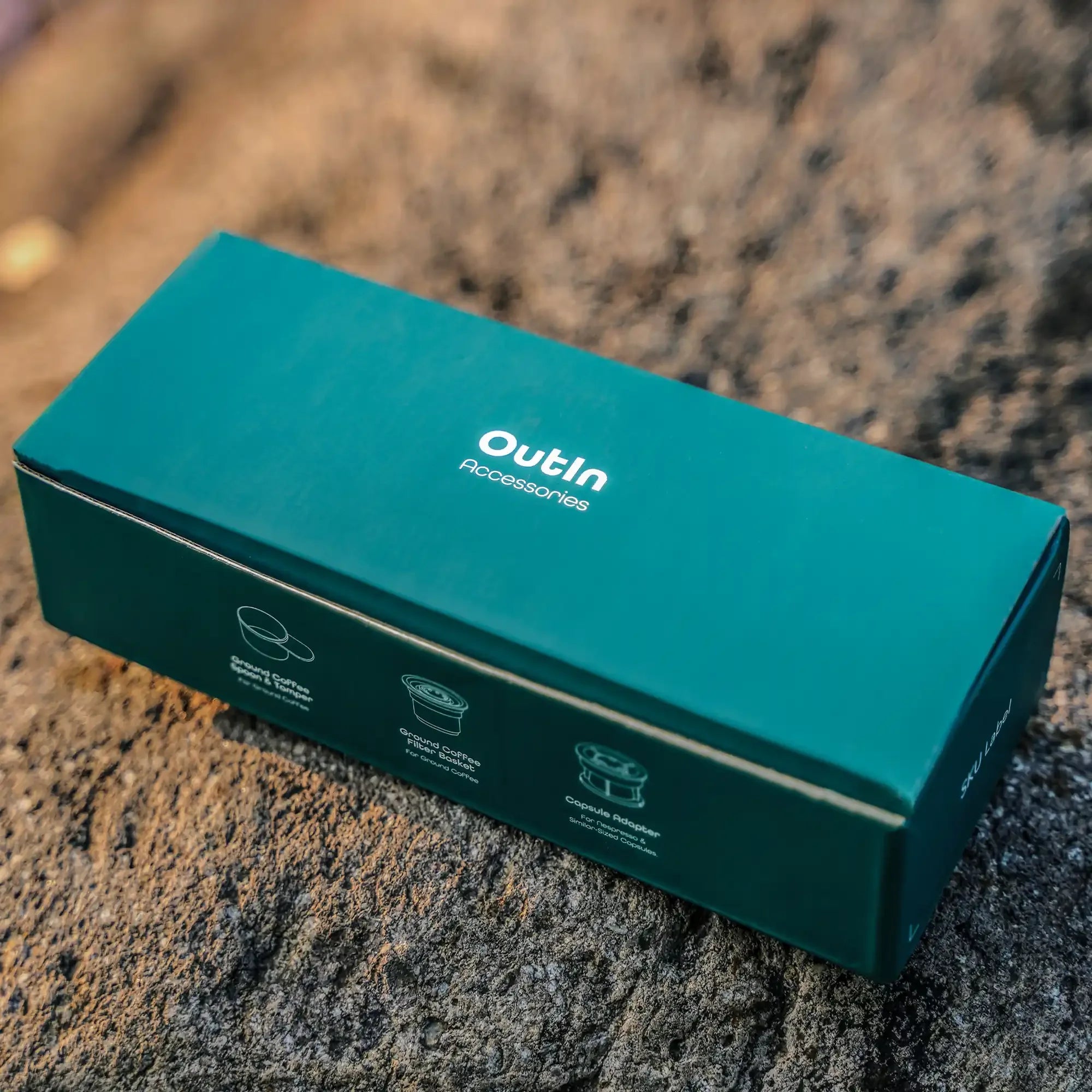 OutIn Accessories Kit box with coffee spoon, filter, capsule adapter illustrations. For OutIn Nano espresso machine.